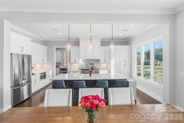 a kitchen with stainless steel appliances kitchen island granite countertop a refrigerator and stove