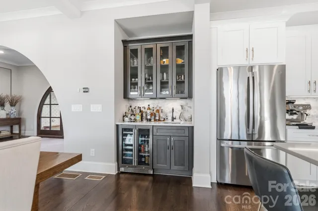 a kitchen with granite countertop a refrigerator and a stove top oven