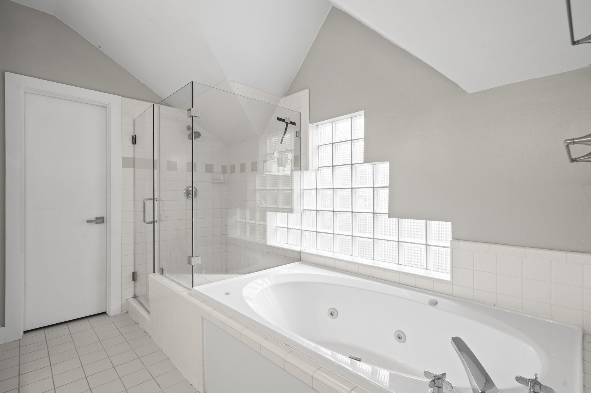 2154 Arabelle Street Houston, TX 77007 - Photo 37 of 45 The ensuite bath gives the primary suite a more elevated feel, with separate spaces for getting ready, showering, and relaxing. The jetted tub adds a quiet touch of comfort at the end of the day.
