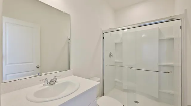 a bathroom with a shower and a sink