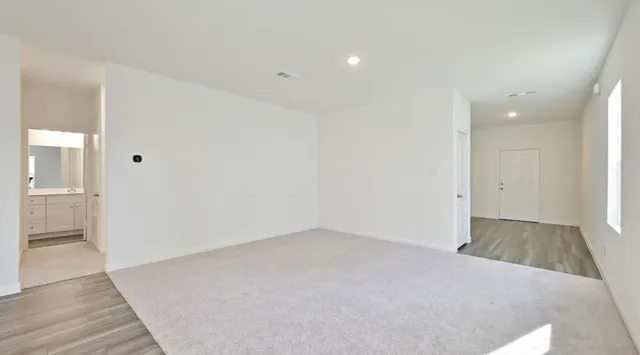 an empty room with wooden floor