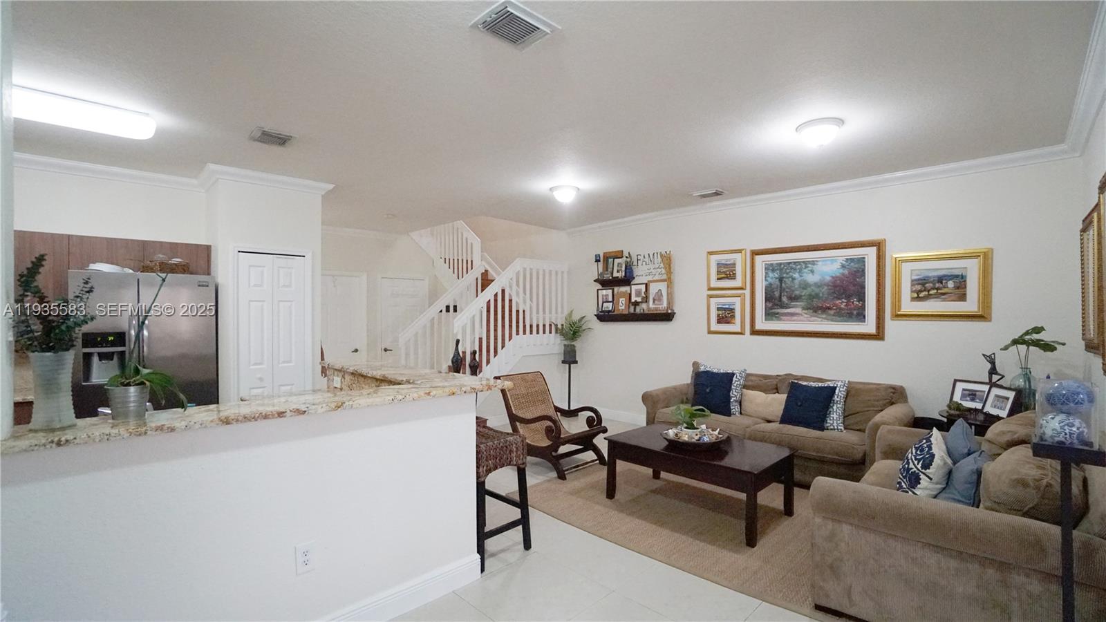 928 Southwest 154th Path, Unit 928 Miami, FL 33194 - Photo 15 of 39 a living room with furniture and a wooden floor