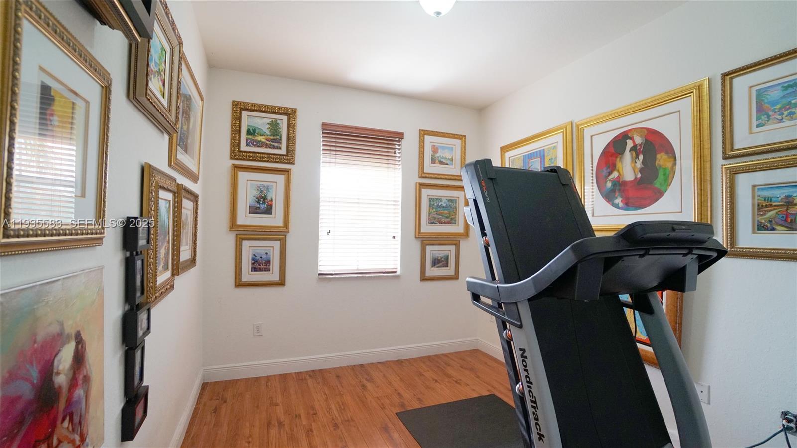 928 Southwest 154th Path, Unit 928 Miami, FL 33194 - Photo 19 of 39 a view of workspace with wooden floor and furniture