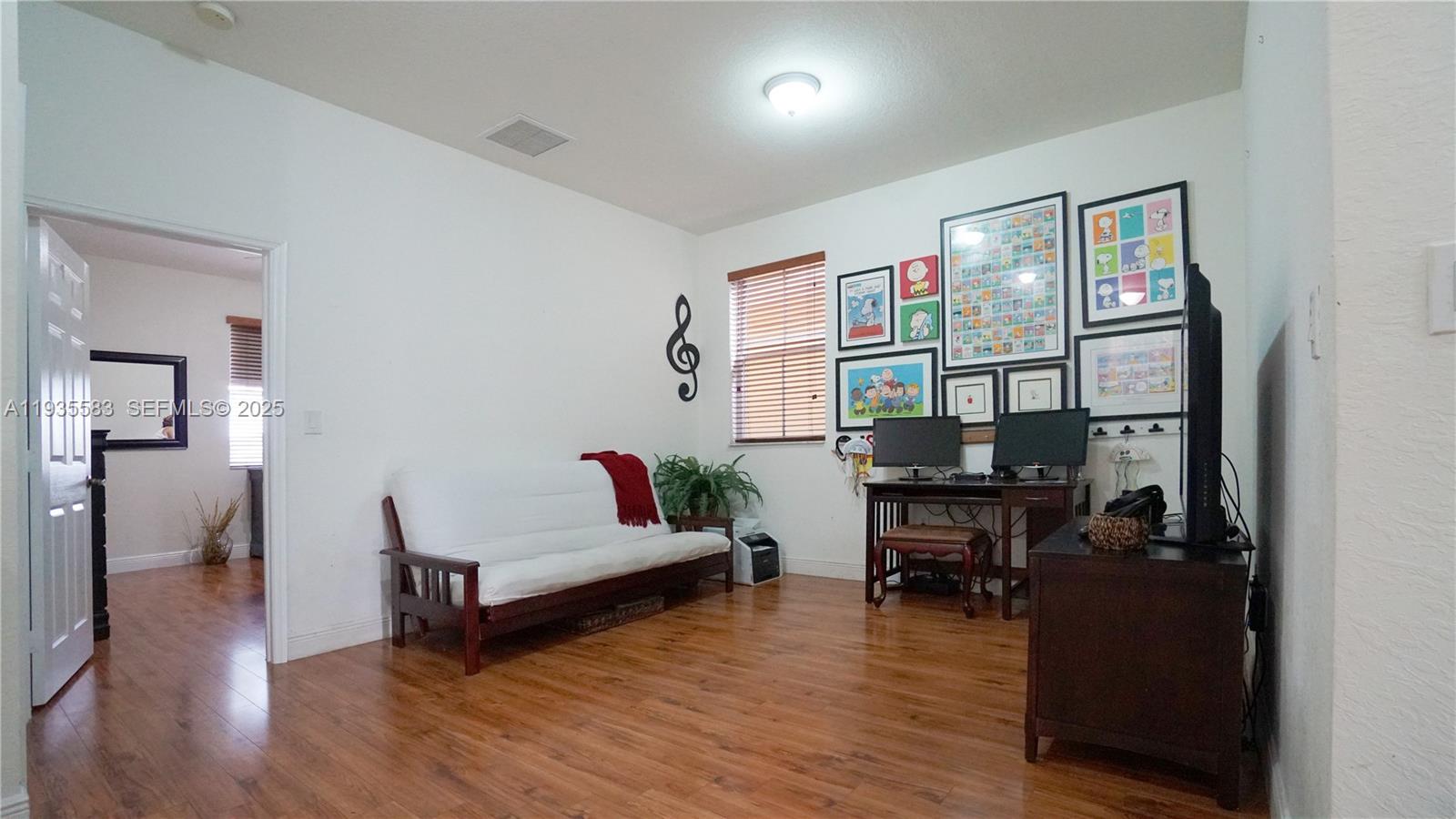 928 Southwest 154th Path, Unit 928 Miami, FL 33194 - Photo 25 of 39 a living room with furniture and wooden floor