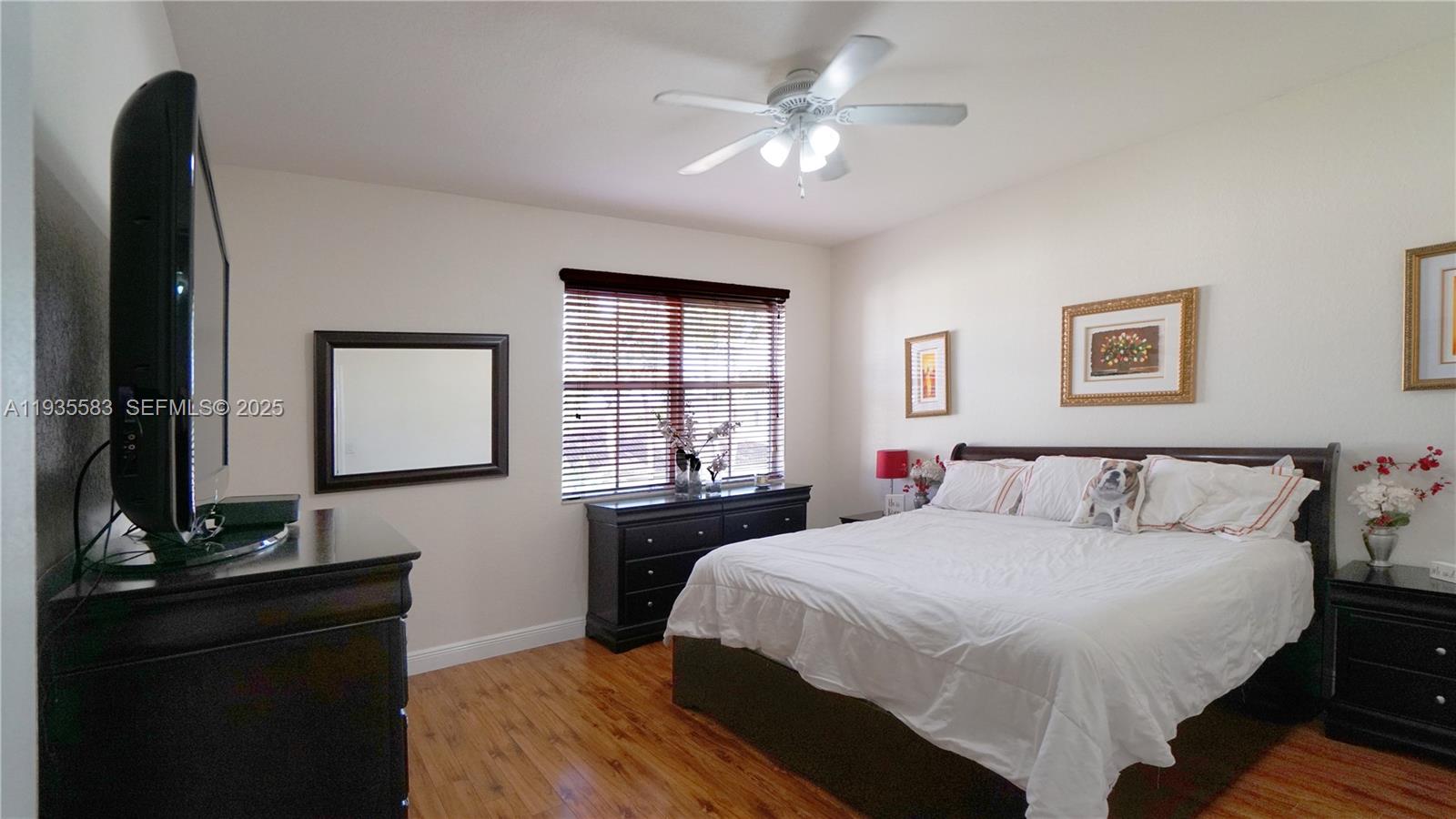 928 Southwest 154th Path, Unit 928 Miami, FL 33194 - Photo 26 of 39 a bedroom with a bed and a dresser