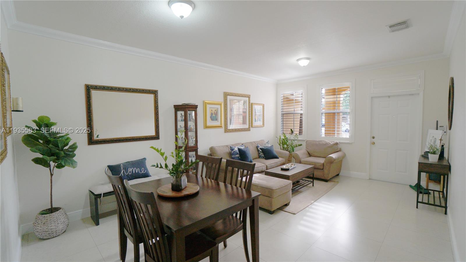 928 Southwest 154th Path, Unit 928 Miami, FL 33194 - Photo 7 of 39 a living room with furniture potted plant and a table