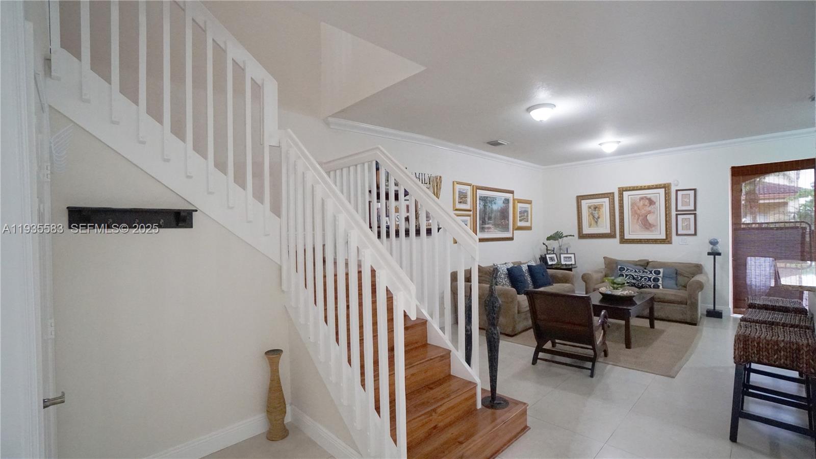928 Southwest 154th Path, Unit 928 Miami, FL 33194 - Photo 9 of 39 a view of a livingroom with furniture and staircase