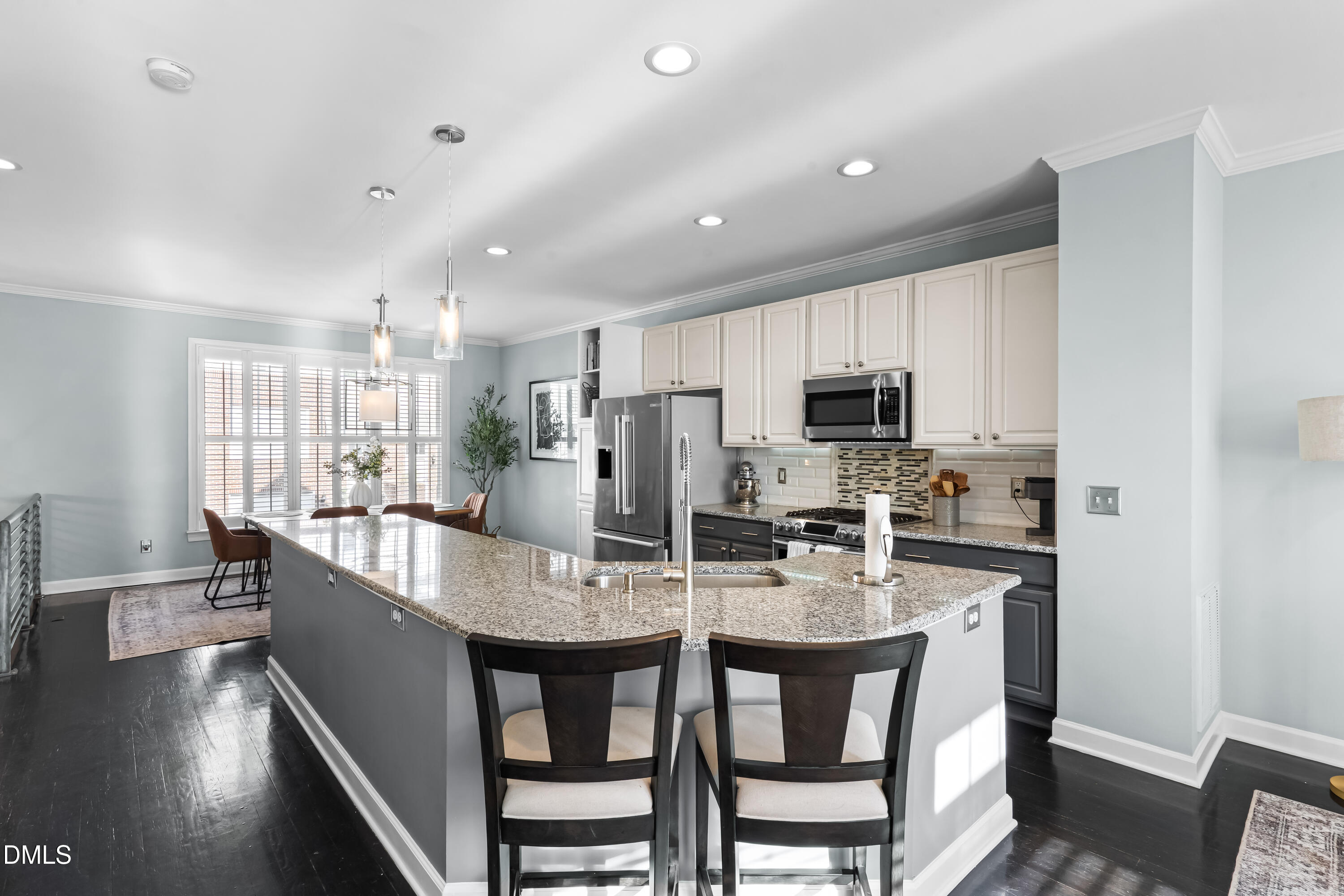 6104 Shandwick Court Raleigh, NC 27609 - Photo 10 of 40 a large kitchen with dining table chairs and stainless steel appliances