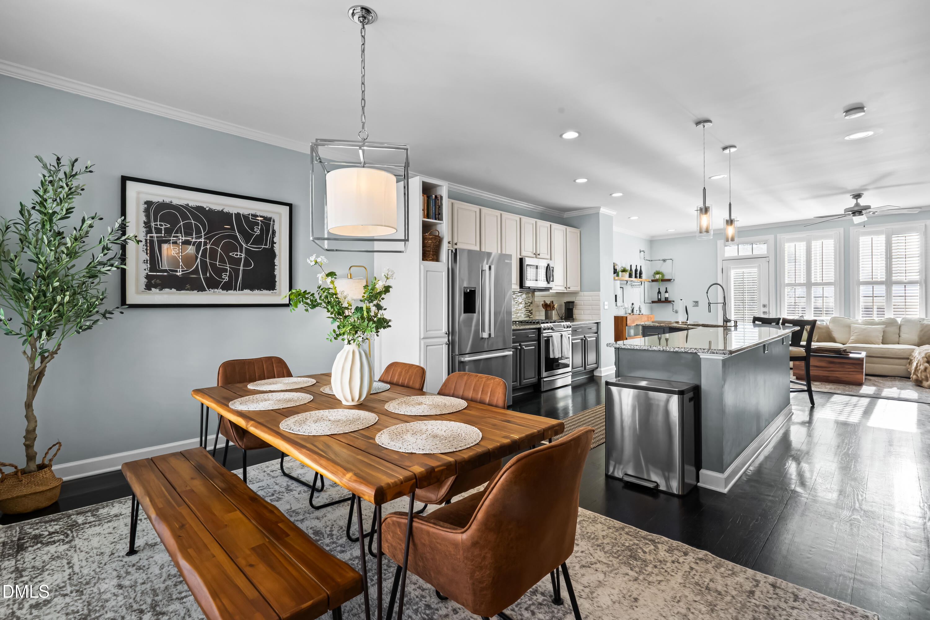6104 Shandwick Court Raleigh, NC 27609 - Photo 5 of 40 a dining room with wooden floor a chandelier a wooden table and chairs