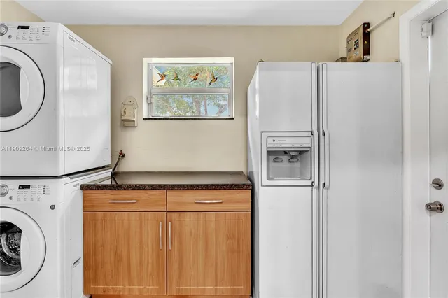 a white refrigerator freezer sitting inside of a kitchen
