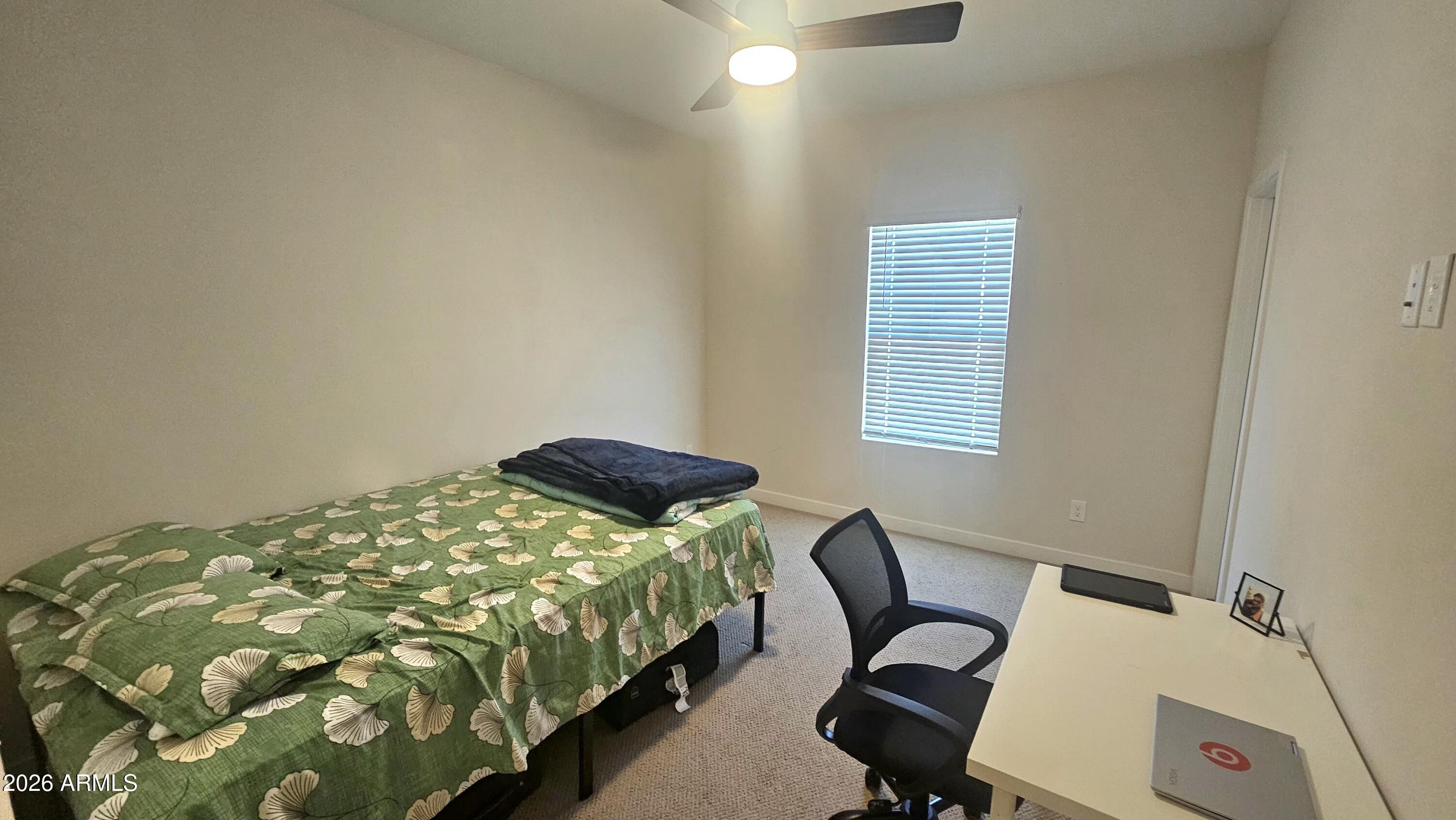 2818 West Red Fox Road Phoenix, AZ 85085 - Photo 11 of 19 a bedroom with a bed and a window