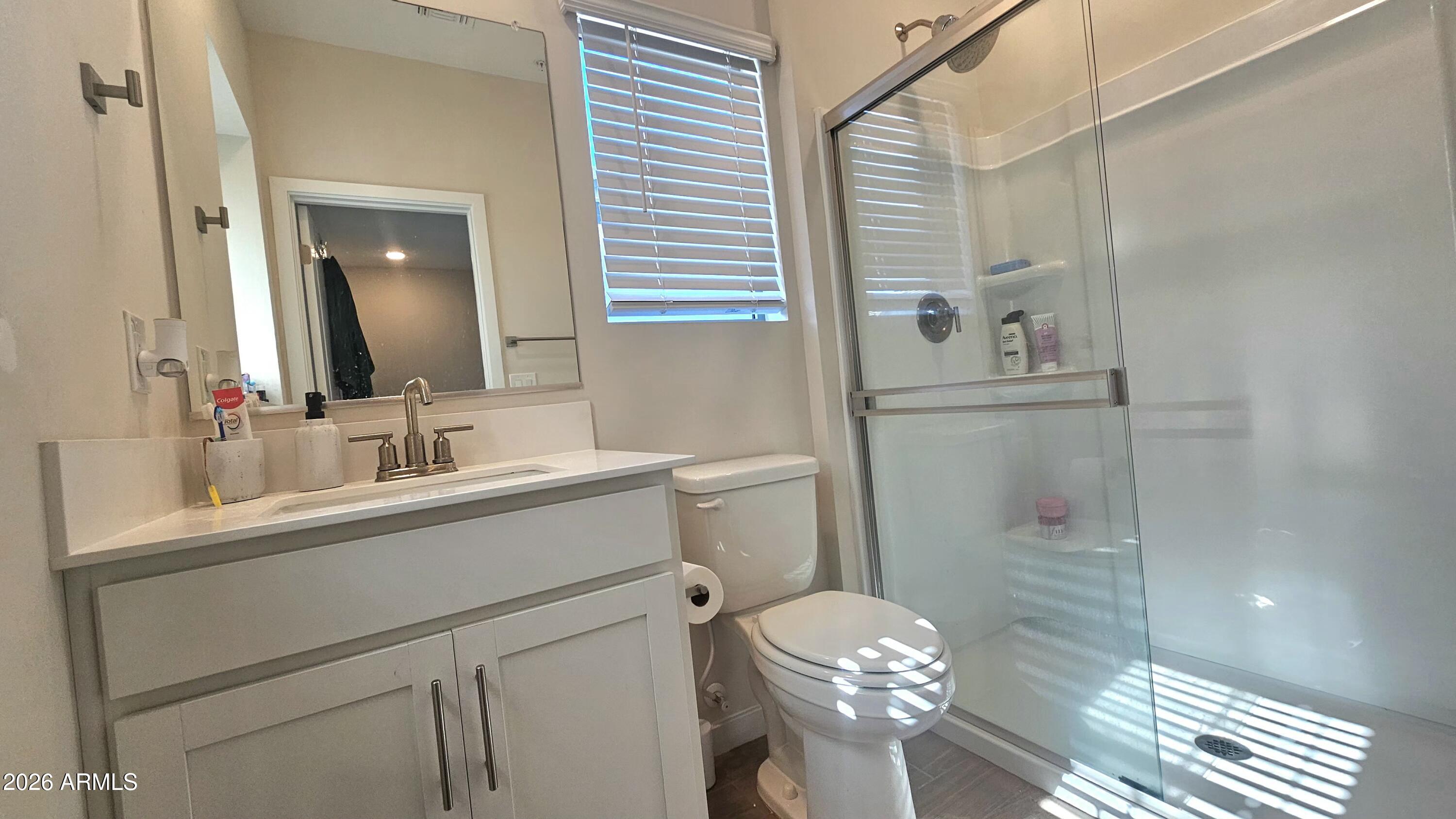 2818 West Red Fox Road Phoenix, AZ 85085 - Photo 12 of 19 a bathroom with a sink a toilet and shower