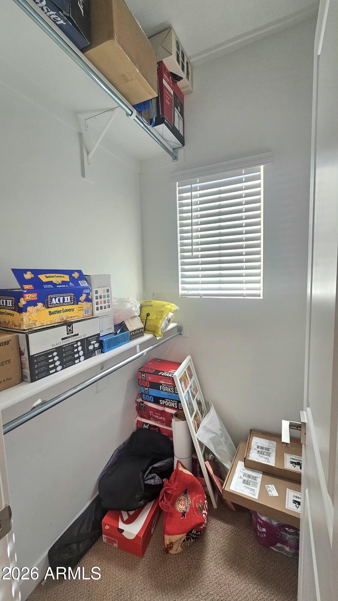 2818 West Red Fox Road Phoenix, AZ 85085 - Photo 13 of 19 a bedroom with a bed and a chandelier