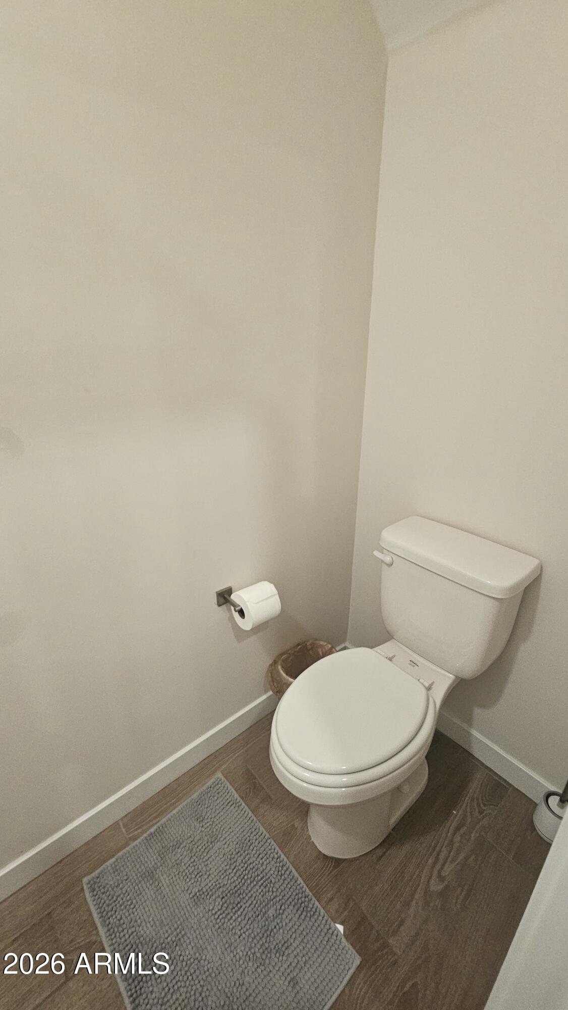 2818 West Red Fox Road Phoenix, AZ 85085 - Photo 14 of 19 a white toilet sitting next to a white wall