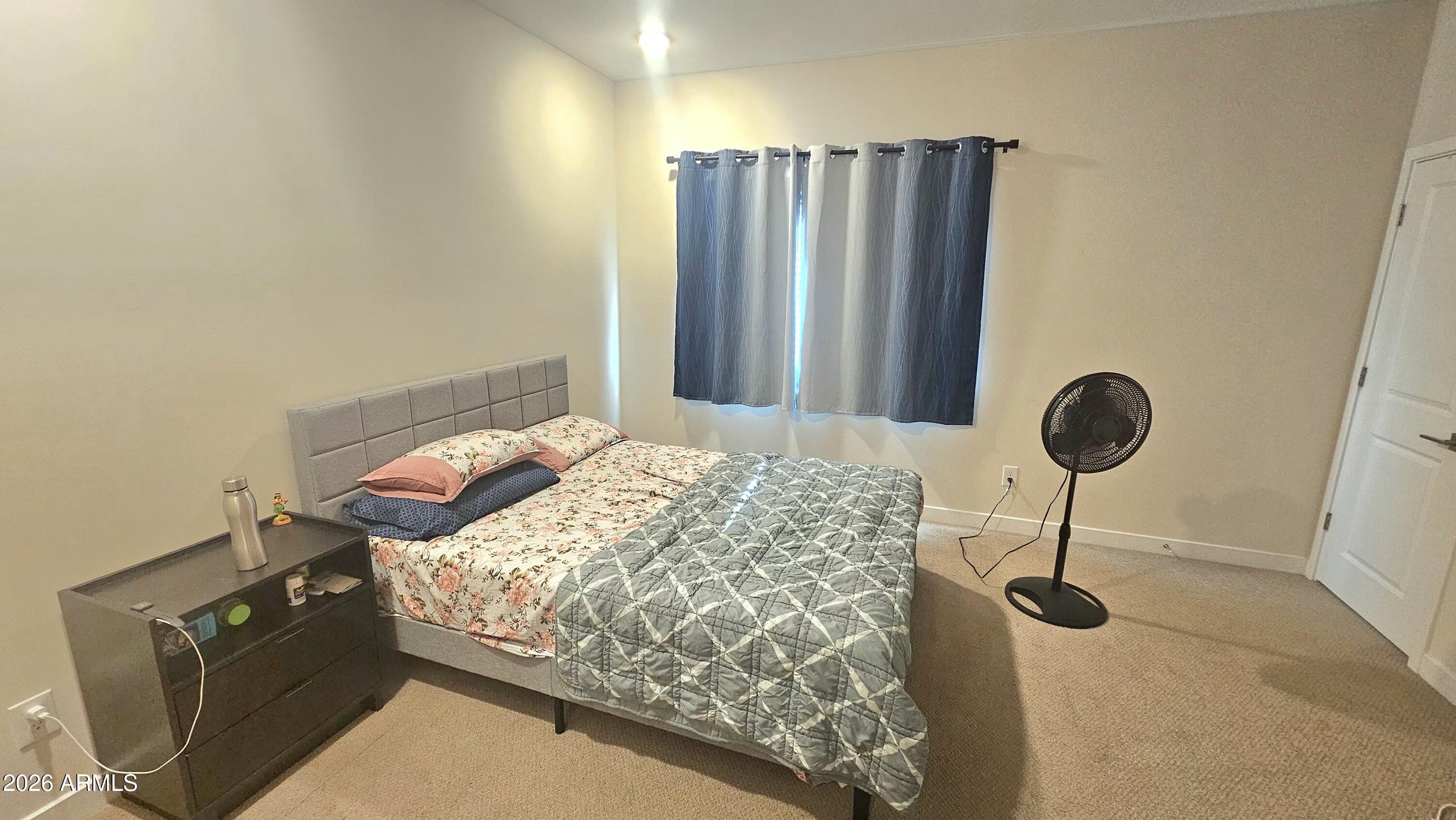 2818 West Red Fox Road Phoenix, AZ 85085 - Photo 6 of 19 a bedroom with a bed and a chandelier