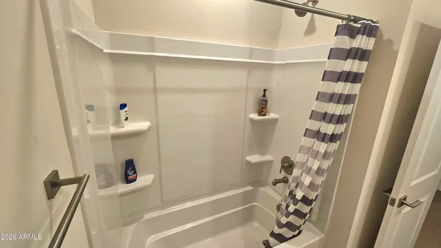a bathroom with a shower and a tub