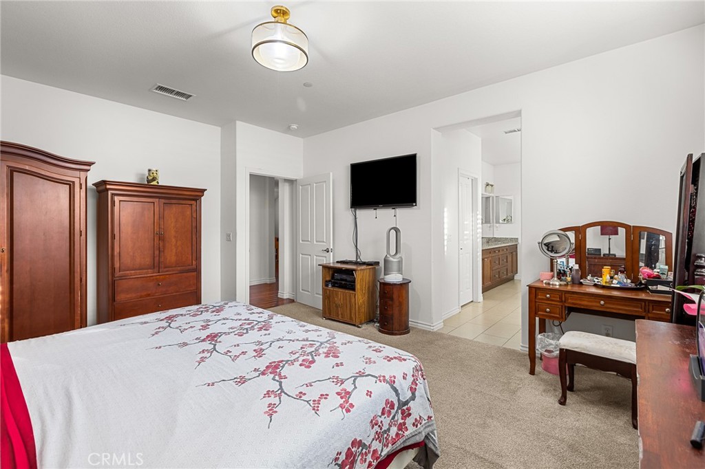 1575 North Grove Street Redlands, CA 92374 - Photo 19 of 45 a bedroom with a bed and a flat screen tv