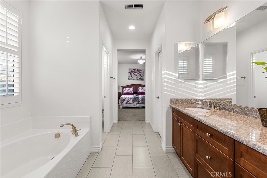 1575 North Grove Street Redlands, CA 92374 - Photo 21 of 45 a en suite bathroom with a granite countertop tub sink and mirror