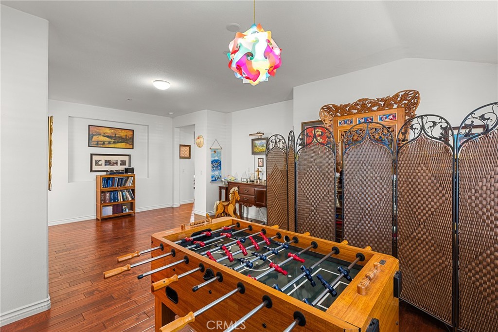 1575 North Grove Street Redlands, CA 92374 - Photo 25 of 45 a bedroom with a bed and a chandelier