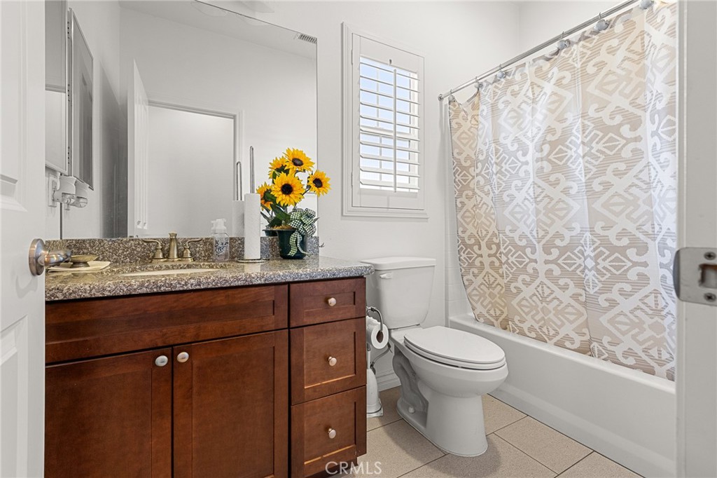 1575 North Grove Street Redlands, CA 92374 - Photo 27 of 45 a bathroom with a granite countertop sink toilet and mirror