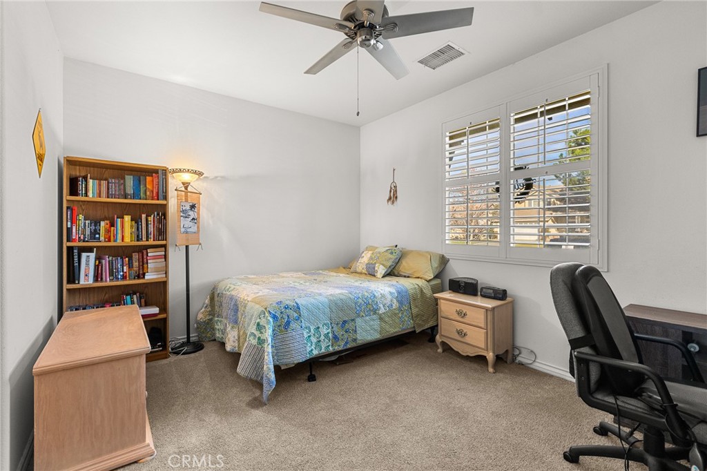 1575 North Grove Street Redlands, CA 92374 - Photo 28 of 45 a bedroom with a bed and a chandelier