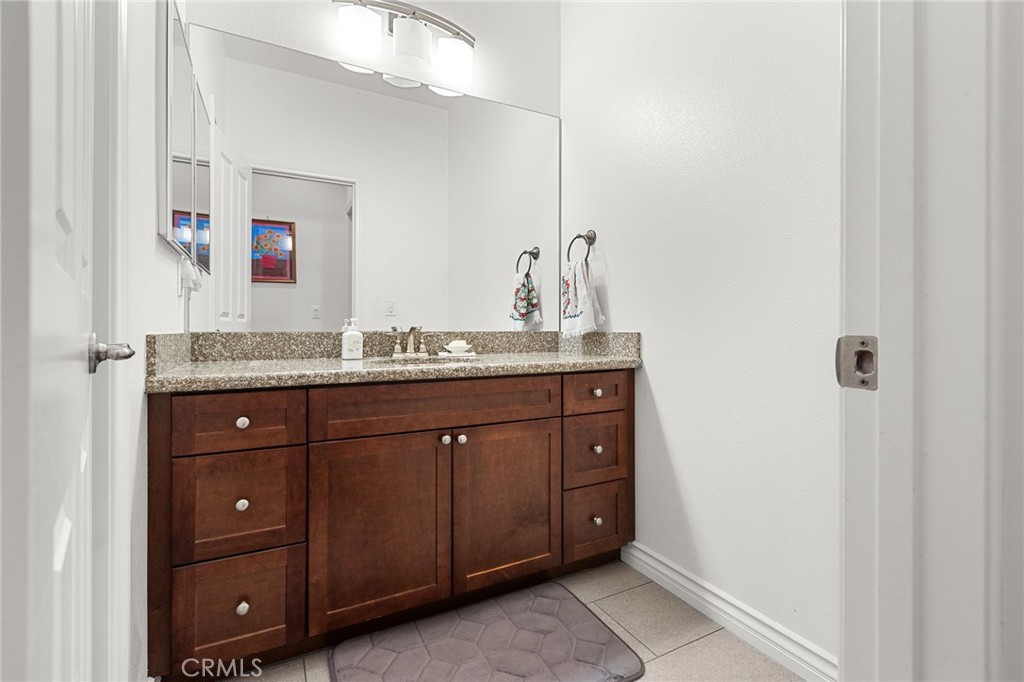 1575 North Grove Street Redlands, CA 92374 - Photo 30 of 45 a bathroom with a granite countertop double vanity sink and mirror