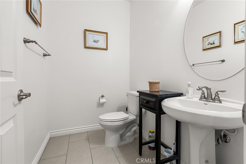 1575 North Grove Street Redlands, CA 92374 - Photo 32 of 45 a bathroom with a toilet sink and mirror