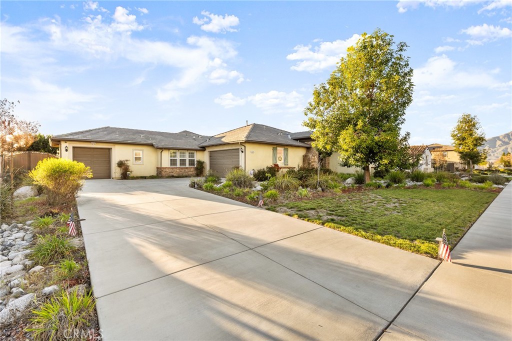1575 North Grove Street Redlands, CA 92374 - Photo 4 of 45 a front view of a house with a yard and trees