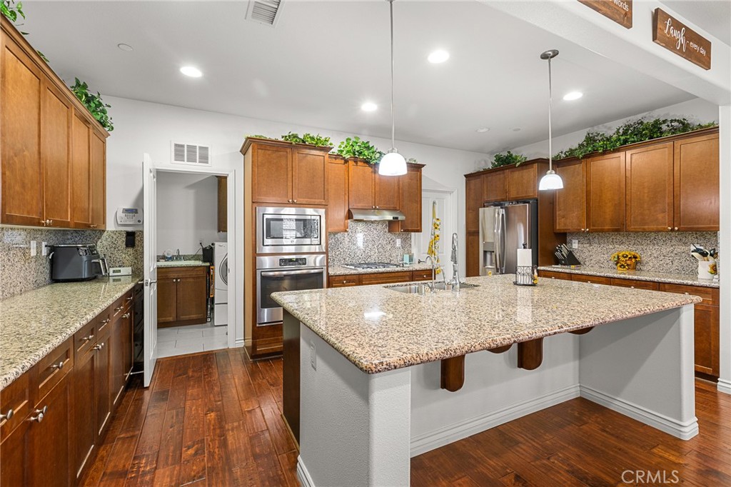 1575 North Grove Street Redlands, CA 92374 - Photo 8 of 45 a kitchen with stainless steel appliances granite countertop wooden cabinets and sink
