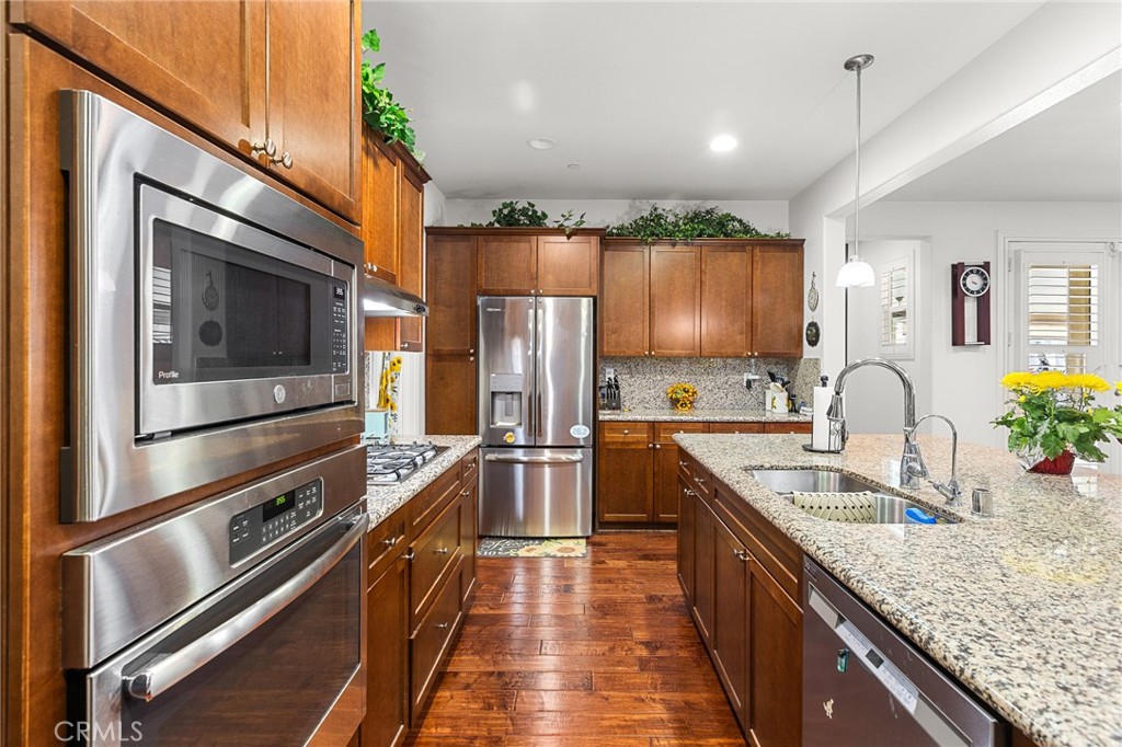 1575 North Grove Street Redlands, CA 92374 - Photo 9 of 45 a kitchen with stainless steel appliances granite countertop a sink a stove and cabinets
