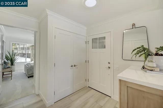 a bedroom with a bed and a large mirror