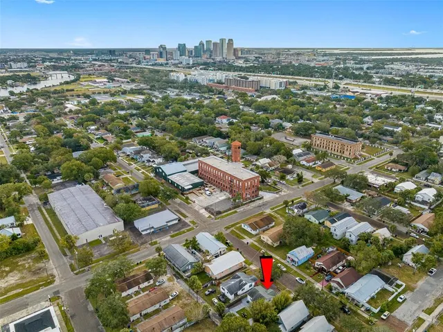 an aerial view of residential houses with city view