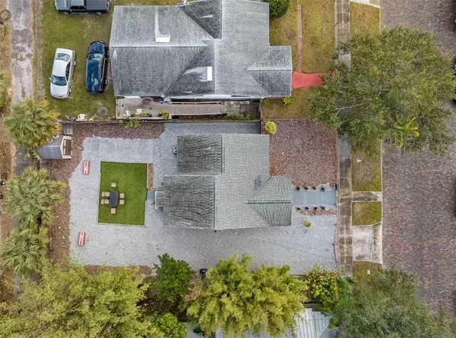 an aerial view of a house with a yard and fountain in middle