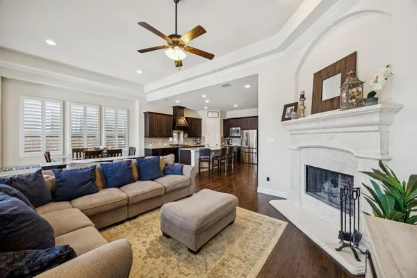 a living room with furniture fireplace and a large window