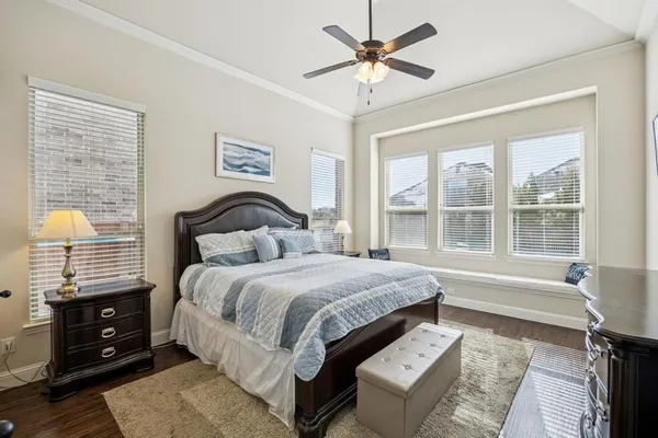 a bedroom with a large bed and a window