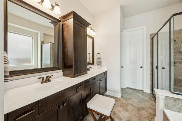 a bathroom with a sink double vanity and a mirror