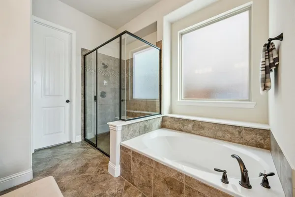 a bathroom with a tub and a shower