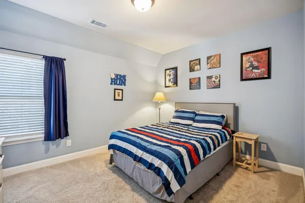 a bedroom with a bed and wall painting