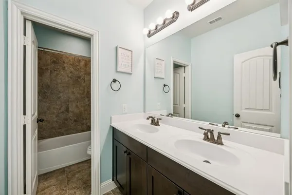 a bathroom with a sink a mirror and a bathtub