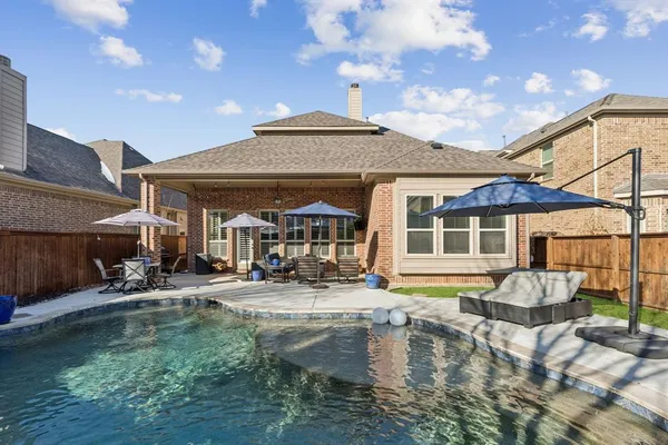a front view of a house with swimming pool and porch