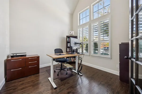 a view of a workspace with furniture and a window