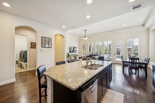 a kitchen with center island table and chairs