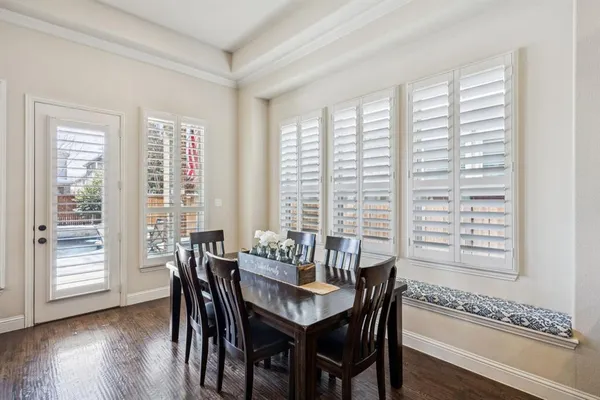 a dining room with furniture and wooden floor