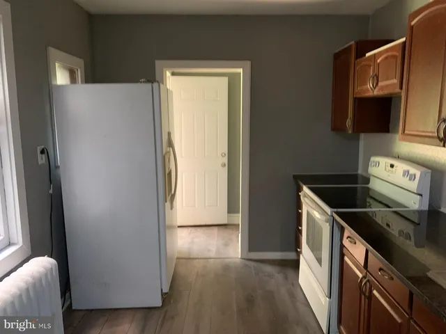 a kitchen with a refrigerator stove and sink
