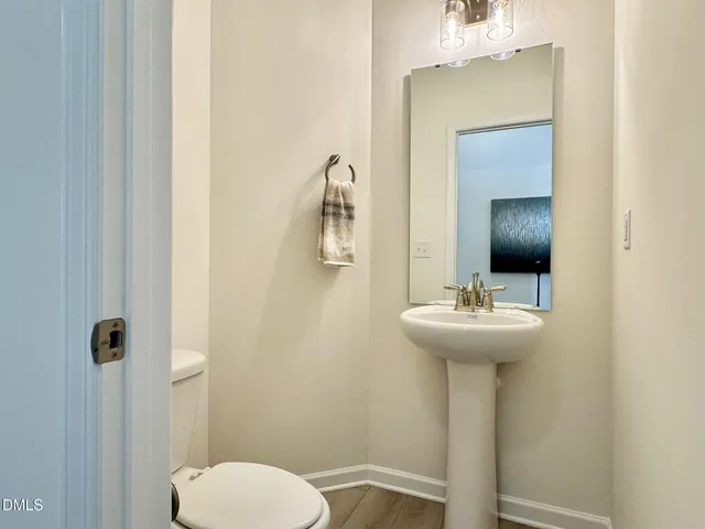 a view of a room with a hallway to rooms