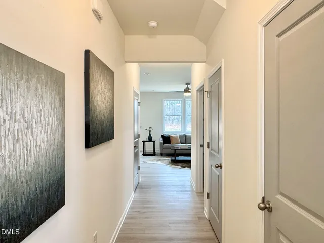 a hall way with a furniture and wooden floor