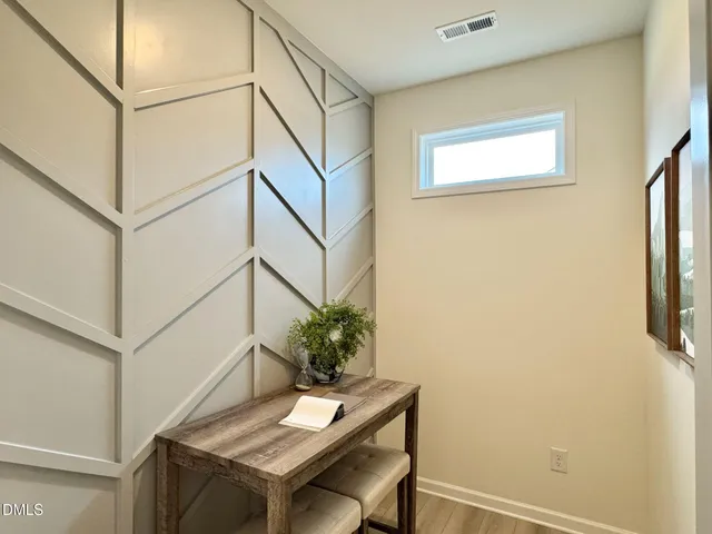 a kitchen with stainless steel appliances kitchen island granite countertop a dining table chairs and a refrigerator