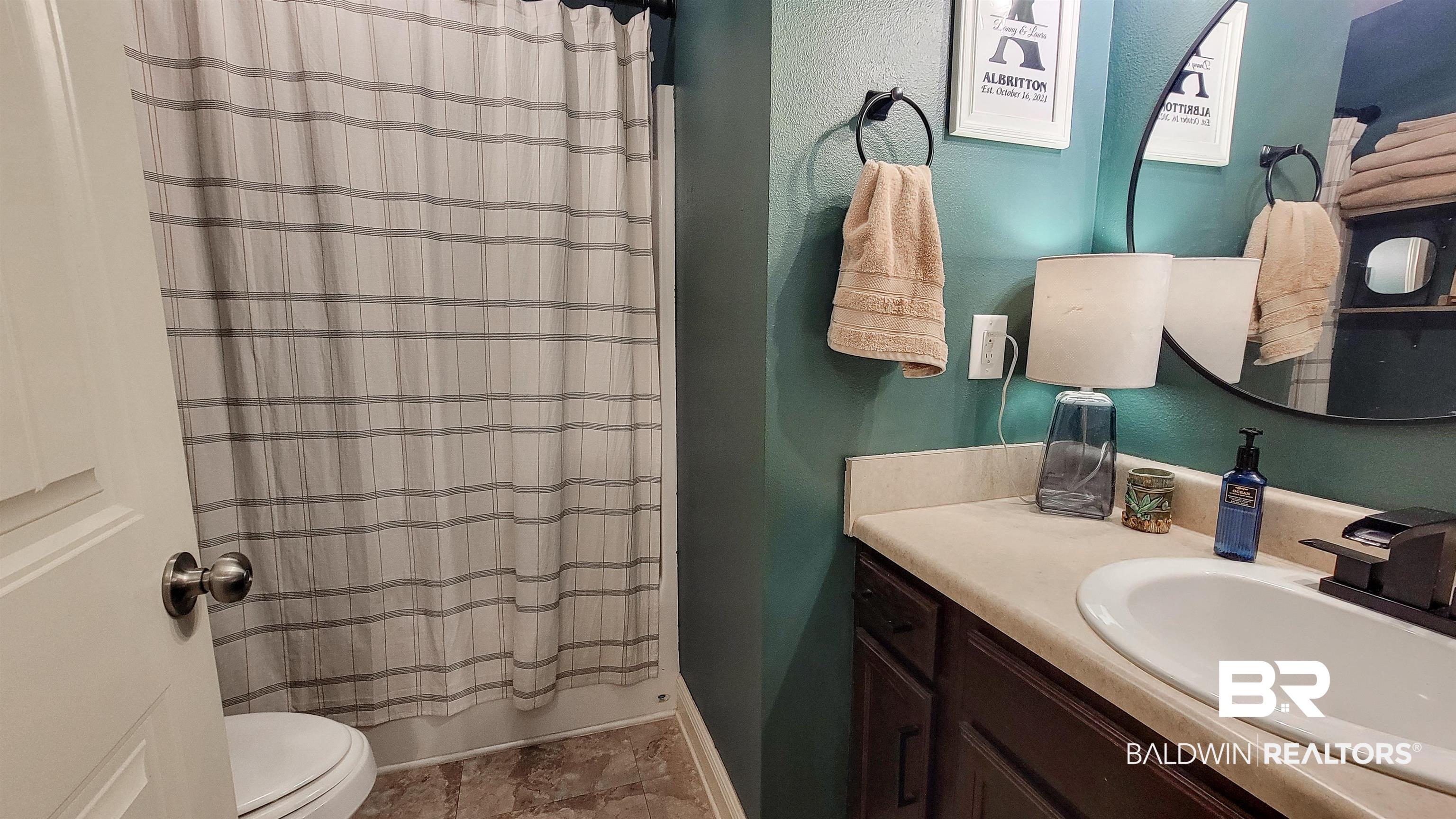 1304 Majesty Loop Foley, AL 36535 - Photo 19 of 44 Full bathroom featuring vanity, a textured wall, and shower / bath combo