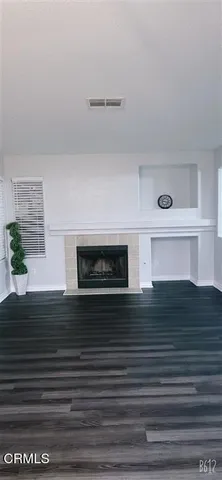 a view of an entryway with wooden floor and a sink