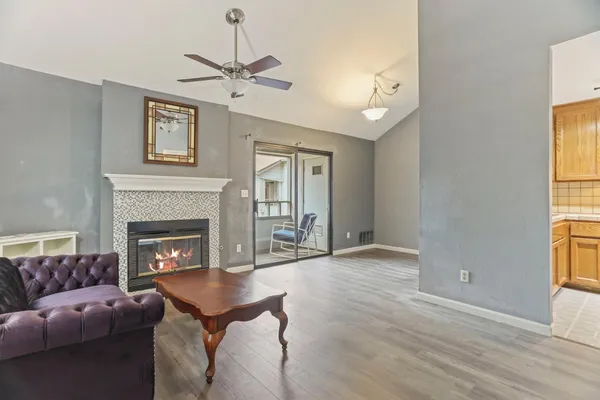 a living room with furniture a window and a fireplace